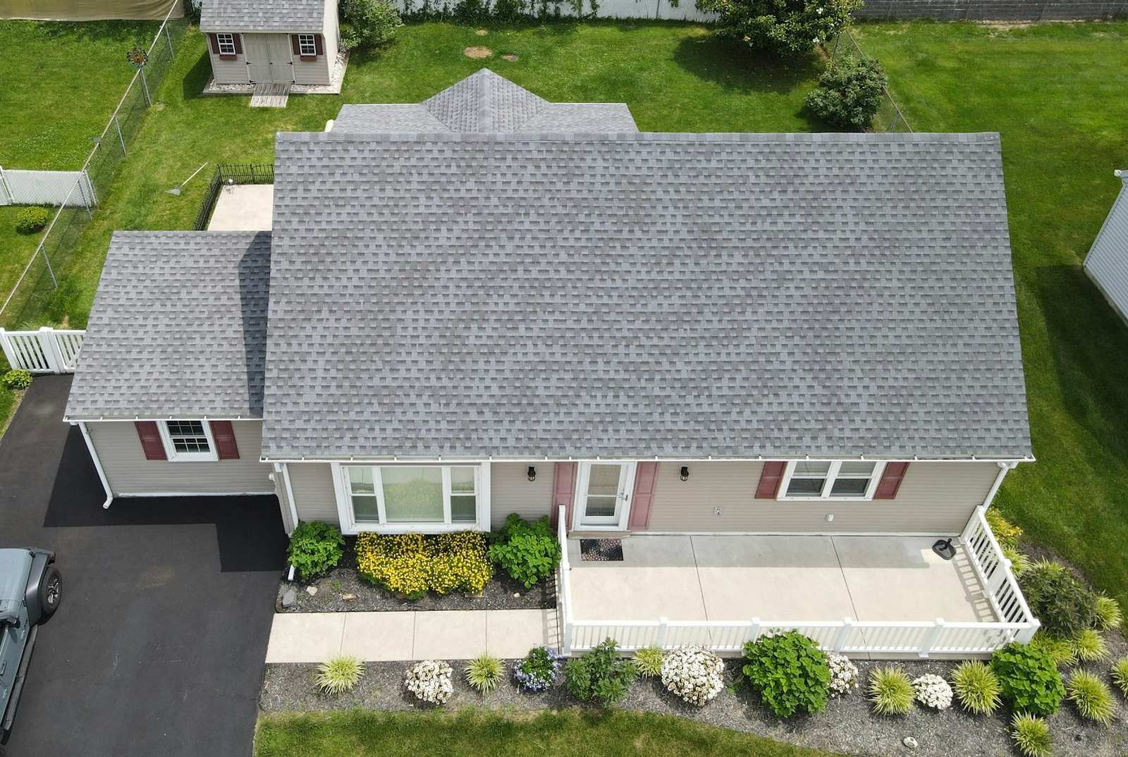 Aerial view of a freshly finished shingle roof on a residential home
